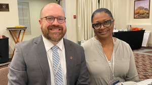 Male and female colleague smiling together