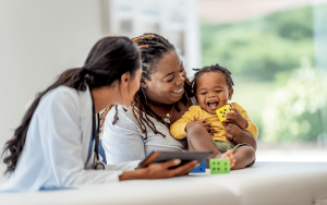 Mom and happy baby receiving care from a doctor