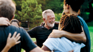 Diverse, smiling people in a group hug